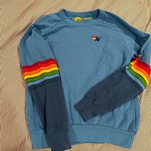 Rainbow Stitch Sleeve Crew Sweatshirt. Color is Ocean with Blue Sleeves. X-Small